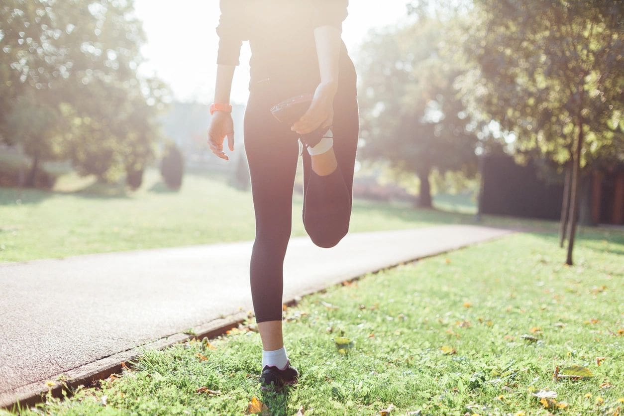 A person is stretching in the grass