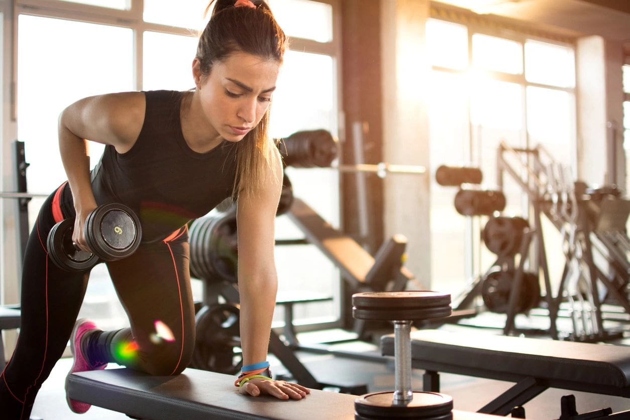 A woman is working out in the gym