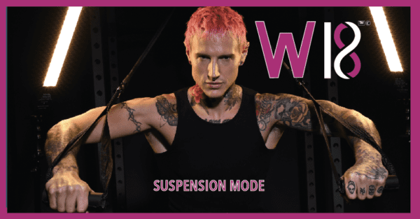 A man with pink hair and tattoos is posing for the camera.